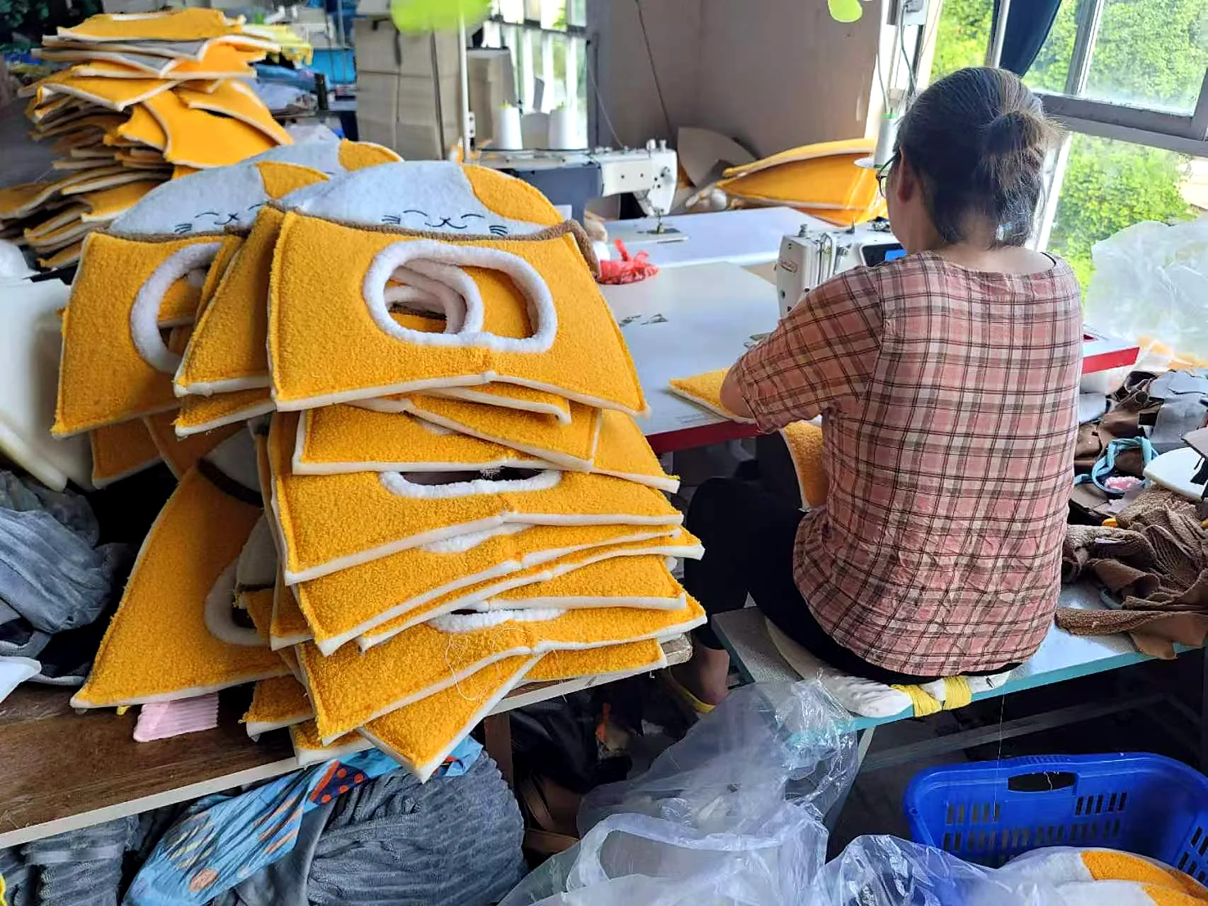 Pet house components being sewn in a pet products workshop